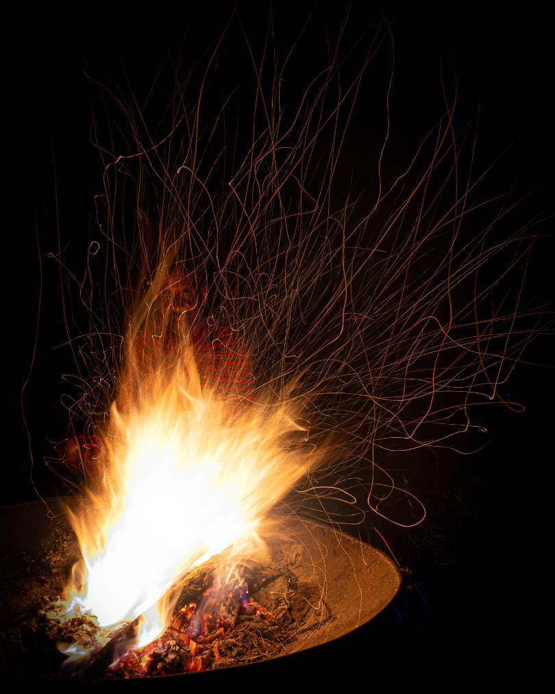 An image of ENkishui Safari Camp manager Dickson Sakaya through the fire